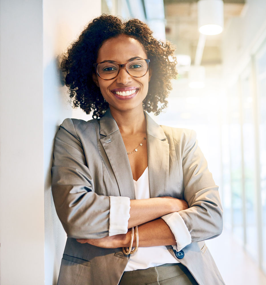 Female entrepreneur smiling at camera with arms folded